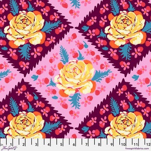 May include: A floral fabric design featuring large yellow roses with orange accents, surrounded by teal leaves and small red flowers. The background is a light pink with a repeating pattern of the same flowers and dark purple diamond shapes.