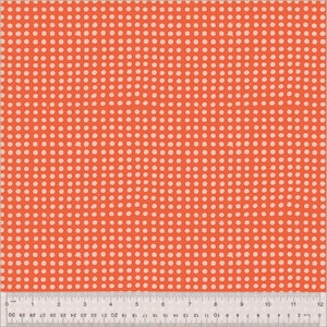 May include: Close-up of a fabric with a repeating pattern of small, off-white polka dots on a bright orange background. A ruler is at the bottom, showing measurements in inches. The fabric is likely used for sewing or crafting projects.