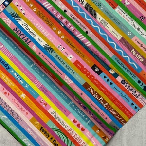 May include: Colorful fabric with vertical stripes of various colors, each featuring text like "Florida," "Eye Candy," and "Sarah Watts." The design includes floral and geometric patterns, with text in white and other colors.