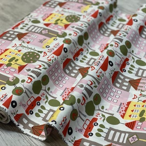 May include: White cotton fabric with a repeating pattern of colorful houses, trees, cars, and birds. The houses are pink, yellow, and gray with red roofs. The trees are green and the cars are red and yellow.
