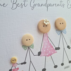 May include: A handmade card with the text "The Best Grandparents Ever" and a family of stick figures made from buttons. The stick figures are labeled "Nanny", "Grandad", "Dalton", and "Milly".
