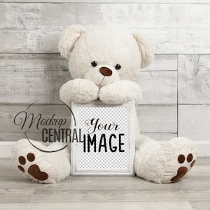 Nursery Teddy Bear Frame Poster Mockup Sign, Giant Stuffed Animal Holding Frame on Wood Background, Photography Product Mockup