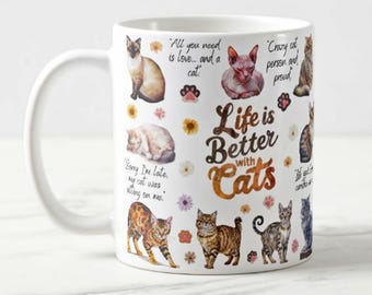 May include: White ceramic mug featuring various cat illustrations and the text "Life is Better with Cats." The mug includes quotes and paw prints, with a white handle.