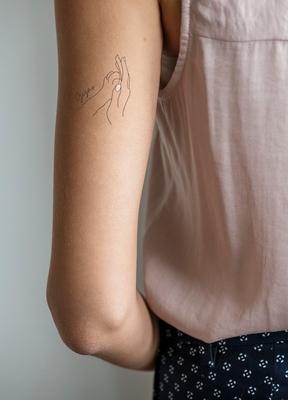 hands touching painting tattoo