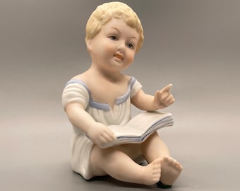 Vintage Porcelain Bisque Piano Baby, Child with Book Figurine