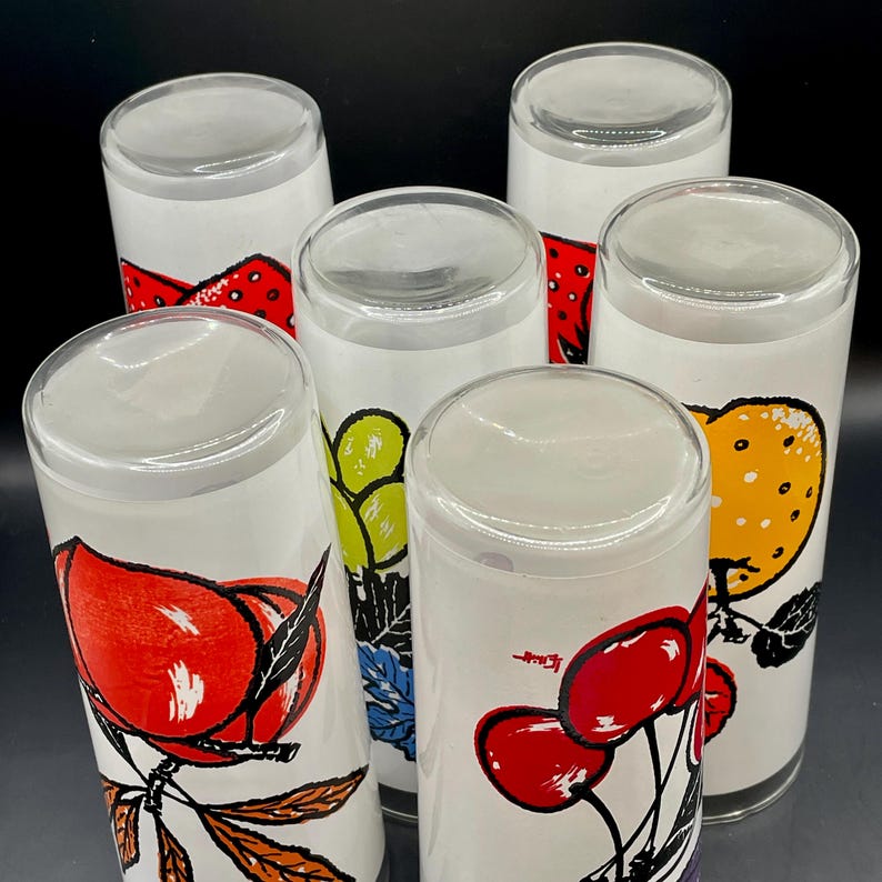 K&ouml;nnte beinhalten: Satz von sechs klaren Trinkgl&auml;sern aus Glas mit bunten Fruchtmotiven. Die Gl&auml;ser zeigen eine Vielzahl von Fr&uuml;chten, darunter Erdbeeren, Trauben, Pfirsiche, Kirschen und Orangen.