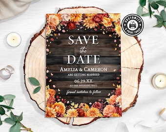 May include: Save the date wedding announcement with a rustic wood background and fall floral border. The text reads "Save the Date, Amelia & Cameron are getting married, 06.29.XX at the Wedding Hall, formal invitation to follow."