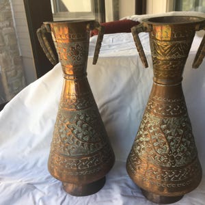 Two Vintage Middle Eastern Repousse Copper over Tin Vases with Drop Handles