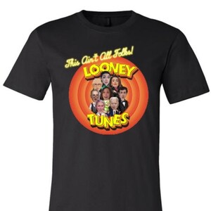 May include: Black t-shirt with a yellow and red graphic of a cartoon character with the text "This Ain't All Folks!" "Looney Tunes" and a group of people's faces.
