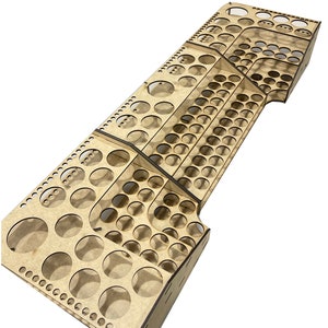 May include: A wooden paint pot holder with multiple tiers and rows of circular holes for storing paint pots. The holder is made of light brown wood and has a natural finish.