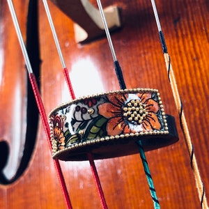 Cello mute with orange flowers