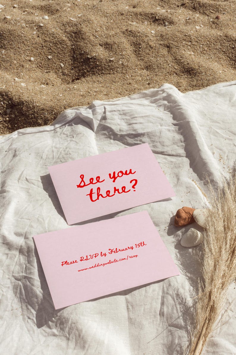 May include: Two pink cards with red text. The top card says "See you there?" and the bottom card says "Please RSVP by February 15th www.weddingwebsite.com/rsvp"