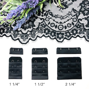 May include: Three black bra strap extenders with hook and eye closures. The extenders are 1 1/4 inches, 1 1/2 inches, and 2 1/4 inches long.