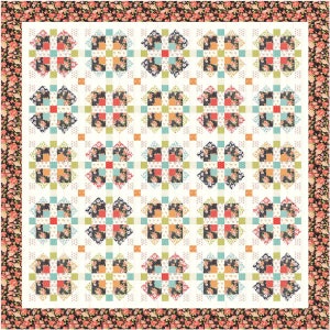 May include: A white quilt with a floral pattern. The quilt is made up of many small squares, each with a different floral design. The quilt is surrounded by a black border with a floral pattern.