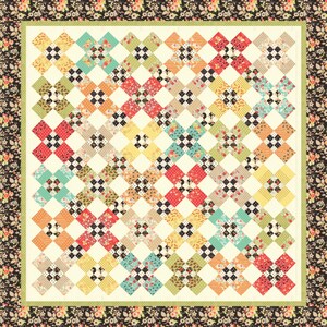 May include: A quilt with a patchwork design featuring a variety of floral prints in shades of red, green, blue, yellow, and black. The quilt is framed with a black and white floral border.