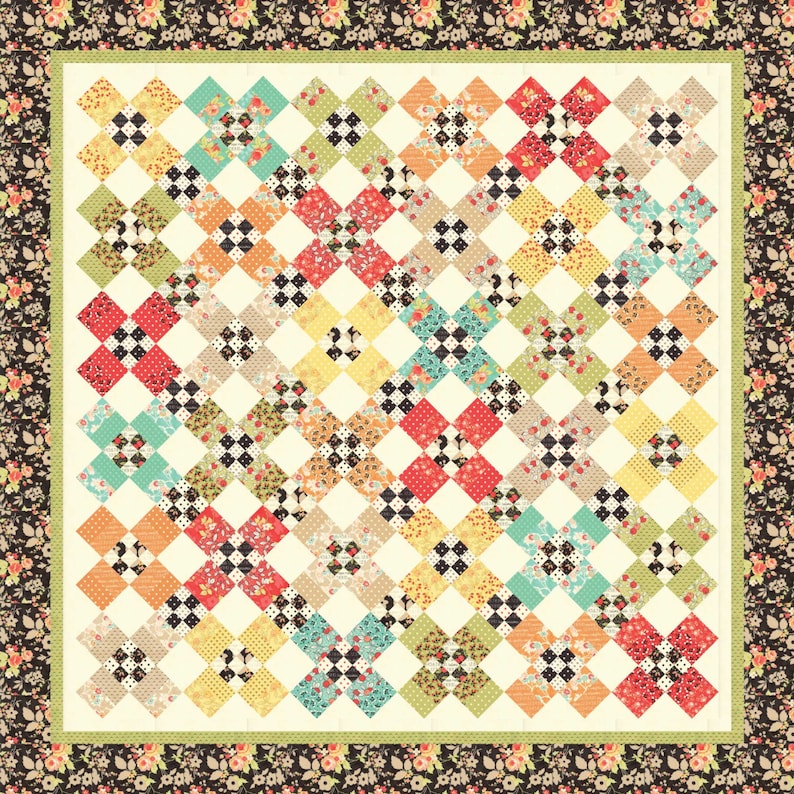 May include: A quilt with a patchwork design featuring a variety of floral prints in shades of red, green, blue, yellow, and black. The quilt is framed with a black and white floral border.