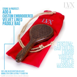 May include: A red velvet lined bag with a drawstring closure and a wooden paddle with a geometric pattern. The bag has the text "LVX" embroidered on it. The text "STORE & PROTECT: ADD A CUSTOM EMBROIDERED VELVET LINED PADDLE BAG" is in the top left corner of the image. The text "CUSTOM: BAG COLOR LINING THREAD FONT & MESSAGE" is in the bottom right corner of the image.
