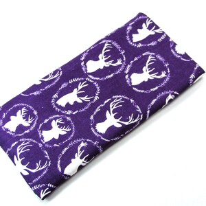 May include: Purple eye mask with a white deer silhouette pattern. The deer are in a wreath design.