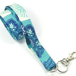 May include: A blue and white patterned lanyard with a silver swivel clip and a silver key ring.