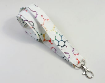 May include: White lanyard with a rainbow colored chemical structure pattern and a silver swivel clip.