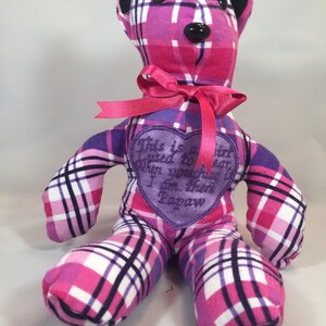 May include: A pink and purple plaid teddy bear with a purple heart-shaped patch that says "This is to say when you're sad I am there for you always".