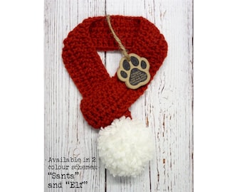 May include: Red crocheted dog scarf with a white pom-pom. Available in two color schemes: "Santa" and "Elf".