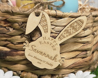 May include: A woven basket with colorful Easter eggs and a wooden bunny-shaped tag. The tag is engraved with "Happy Easter Savannah" and "love Mummy & Daddy". The basket is decorated with a twine bow.