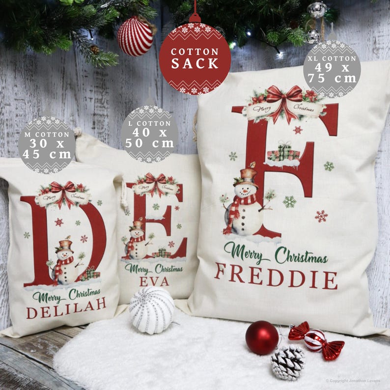 May include: Off-white cotton Christmas sacks with red lettering and snowman illustrations. Sizes include M (11.8 x 17.7 inches), L (15.7 x 19.7 inches), and XL (19.3 x 29.5 inches). Each sack features a name, such as Delilah, Eva, or Freddie.