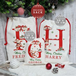 May include: White Christmas sacks with red drawstrings, featuring large red letters and festive illustrations. The sacks are labeled "DELUXE" and come in various sizes, including a 30 x 40 cm and a 50 x 70 cm option. The text "Merry Christmas" is also visible.