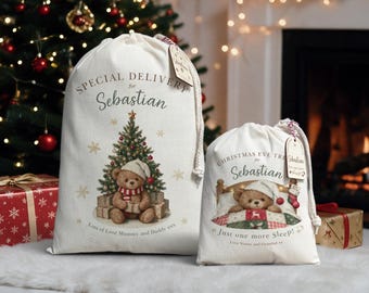 May include: Two off-white canvas drawstring bags featuring festive graphics. The larger bag reads Special Delivery for Sebastian with a teddy bear by a tree. The smaller bag reads Christmas Eve Treat for Sebastian Just one more Sleep! with a teddy bear in bed. Both include personalized gift tags.