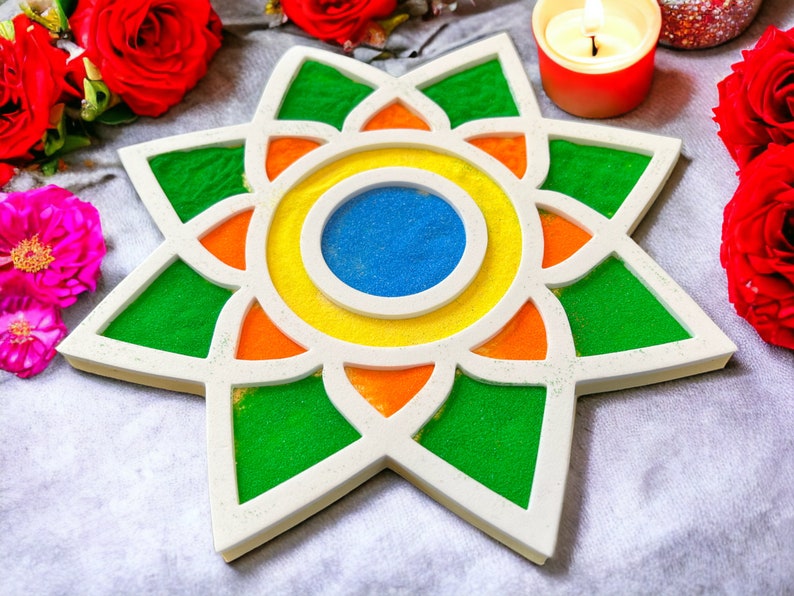 May include: A white star-shaped tray with a colorful mandala design. The mandala features green, orange, yellow, and blue sand. The tray is surrounded by red roses and pink flowers.