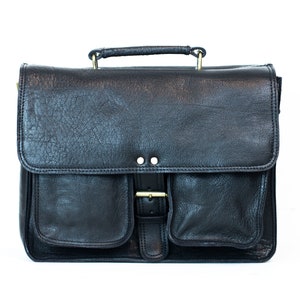 May include: A black leather briefcase with a top handle, two front pockets, and a buckle closure.