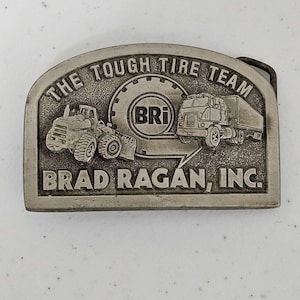 Vintage Brad Ragan Inc. The Tough Tire Team BRi Belt Buckle Metal Illinois