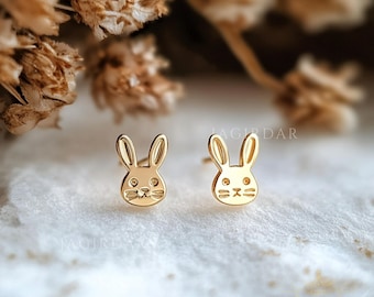 May include: A pair of gold bunny rabbit stud earrings. The earrings are small and delicate, and they would make a great gift for a child or a young woman.