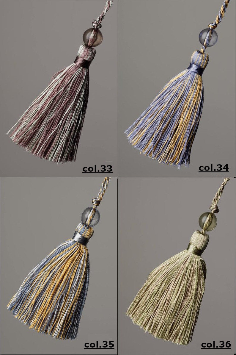 May include: Four tassel ornaments with a decorative bead at the top. The tassels are in four different colour combinations: purple and white, blue and yellow, yellow and blue, and green and brown.