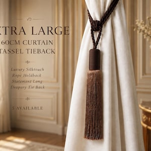 May include: An extra large 60cm curtain tassel tieback featuring a dark brown braided rope and a long, straight, light brown fringe tassel. The text on the image reads: EXTRA LARGE 60CM CURTAIN TASSEL TIEBACK, Luxury Silktouch Rope Holdback, Statement Long Drapery Tie Back, 5 AVAILABLE.