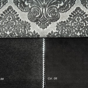 May include: Close-up of three fabric swatches. The top swatch is a grey and white patterned fabric. The bottom two swatches are solid black fabrics. The text "Col. 103", "Col. 4738 - 88", and "Col. 08" are visible.
