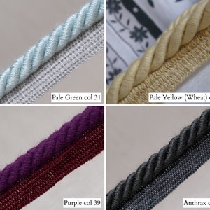 May include: Close-up of four different decorative cords. Pale green, pale yellow, purple, and anthracite colored cords are displayed. Each cord has a twisted rope design. The text "Pale Green col 31", "Pale Yellow (Wheat) col 32", "Purple col 39", and "Anthrax col 40" is included.