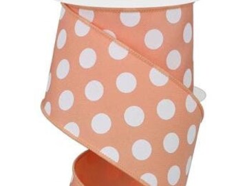 May include: A spool of peach-colored ribbon with white polka dots. The ribbon is 2.5 inches wide.