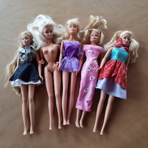 Vintage collection of 5 Mattel Inc. Barbie dolls with blond hair and clothing 1966 and 1995