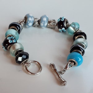 High end blue and black art glass charm bracelet with removable charms blue black white tones