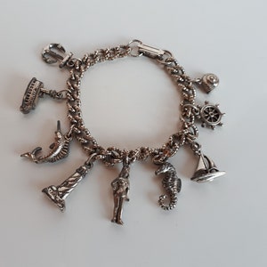 Vintage silver tone metal charm bracelet with nautical theme charms anchor mermaid ship seahorse shell