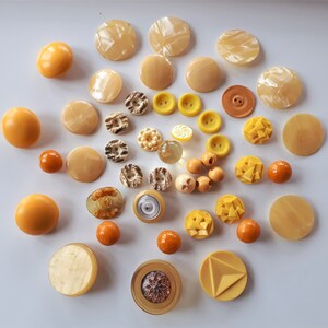Collection of rare Art Deco era vintage mixed yellow egg yolk molded and hand carved plastic collectible buttons sewing craft jewelry make