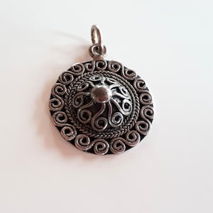 vintage ethnic silver medallion pendant with high relief design