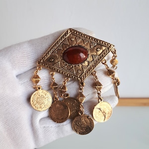 Vintage statement designer textured gold metal red glass cabochon dangle brooch pin with Arabic Islamic faux coins