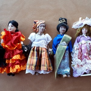 Vintage collection of 6 ethnic porcelain dolls with traditional clothing with painted face hair movable arms legs and gorgeous details