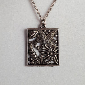 Escena submarina marisqueo estrella de mar tema trabajo abierto colgante de metal plateado collar vintage