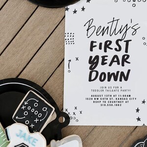 May include: A white rectangular party invitation with black text reading Bently's FIRST YEAR DOWN, JOIN US FOR A TODDLER TAILGATE PARTY, AUGUST 13TH AT 11:00 AM, 1520 NW 54TH ST. KANSAS CITY, RSVP TO COURTNEY AT 310.550.1882, decorated with stars.