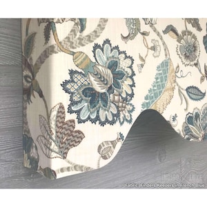 May include: A fabric valance featuring a cream background with a large-scale floral pattern in shades of blue, teal, and brown. The textile displays intricate botanical motifs and scrolling vines. Text at the bottom reads: Fabric: Finders Keepers in French Blue.