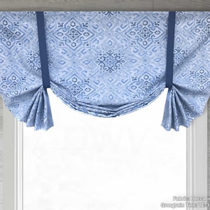 May include: A blue and white patterned valance with a gathered design and navy blue tiebacks. The fabric is called "Becca in Denim" and the tiebacks are "Grosgrain Ties TE 370 Navy".